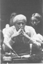 Herbert, looking pensive with students in the background, 1970s